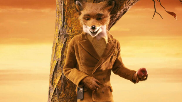 A fox character from Fantastic Mr Fox holding an apple next to a tree in a brown jacket