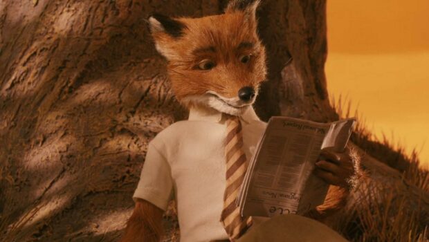 A fox character from Fantastic Mr Fox reading a newspaper outdoors in a natural setting