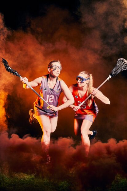 Two lacrosse players compete intensely on the field with their sticks, HD Mobile Wallpaper