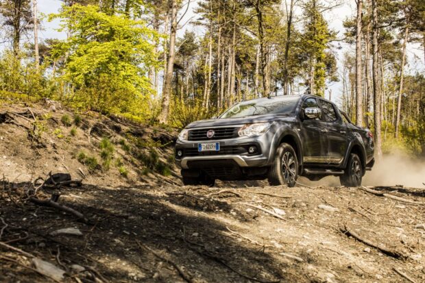 A Fiat Fullback is driving on a dirt path surrounded by trees in a forest, HD Desktop Wallpaper