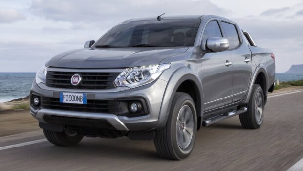 A silver Fiat Fullback is driving on a coastal road with the ocean in the background, HD Desktop Wallpaper