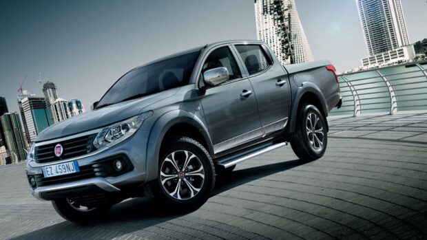 A Fiat Fullback pickup truck parked near modern buildings in the city, HD Desktop Wallpaper