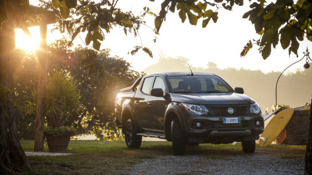 A Fiat Fullback is parked near trees with the sun setting behind it, 2K Desktop Wallpaper