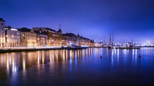Beautiful Finland cityscape with waterfront and illuminated buildings at night