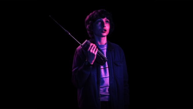A young person looks upwards while holding a vintage radio in purple lighting, HD Desktop Wallpaper