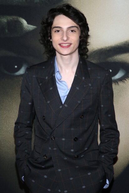 Finn Wolfhard wearing a checkered suit and smiling at an event, HD Mobile Wallpaper