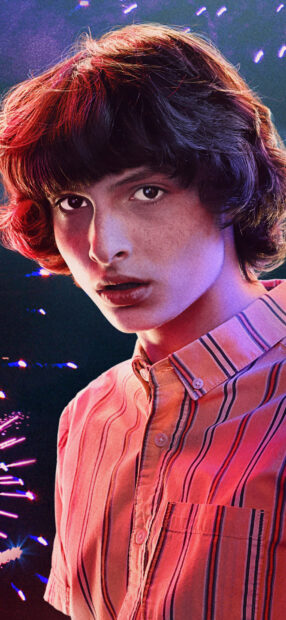 Finn Wolfhard looks intensely into the camera with colorful lighting effects, HD Mobile Wallpaper