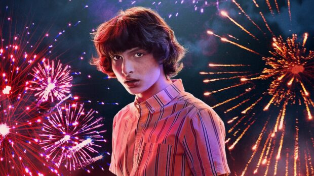 Finn Wolfhard stands in front of colorful fireworks lighting up the night sky, HD Desktop Wallpaper