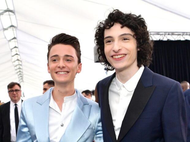 Finn Wolfhard with friend smiling at a formal event, HD Desktop Wallpaper