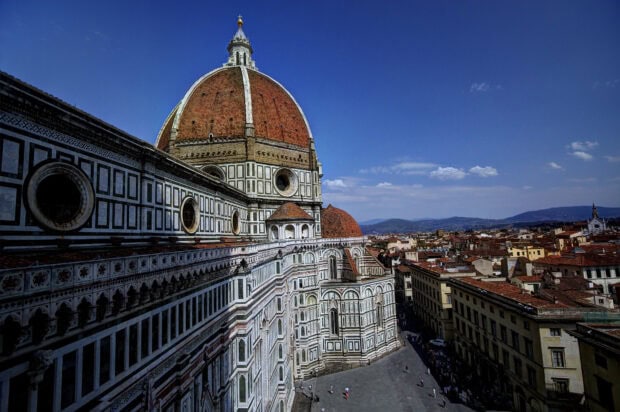 The Florence Wallpapers show a detailed view of the cathedral dome and historic buildings under a clear blue sky, HD Desktop Wallpaper
