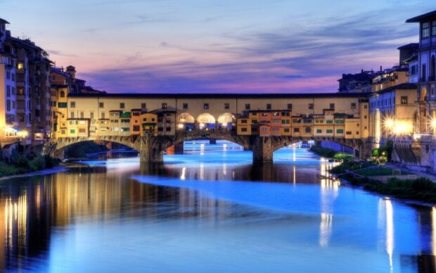 The Florence Wallpapers show the historic Ponte Vecchio bridge reflected in the river at sunset, HD Desktop Wallpaper