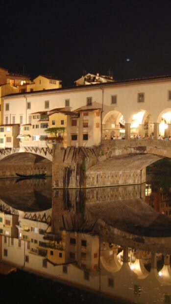 Florence Wallpapers showing the illuminated bridge and buildings reflected on the calm river at night, HD Mobile Wallpaper