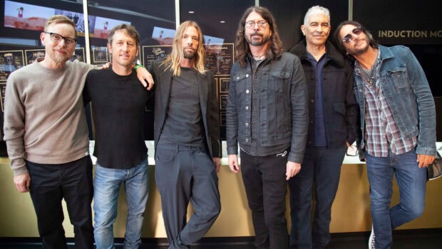 The Foo Fighters band pose together in a casual setting with smiles and relaxed postures, HD Desktop Wallpaper