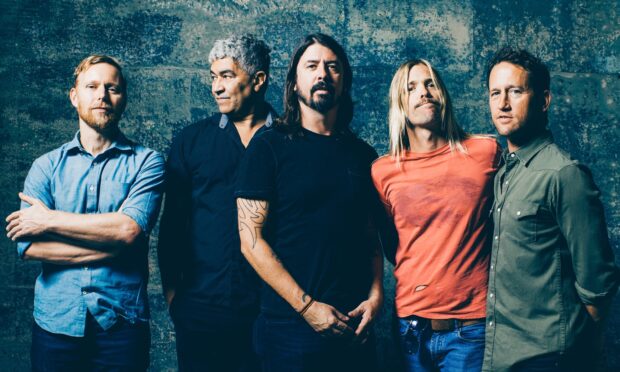 The Foo Fighters band pose together against a textured wall, HD Desktop Wallpaper