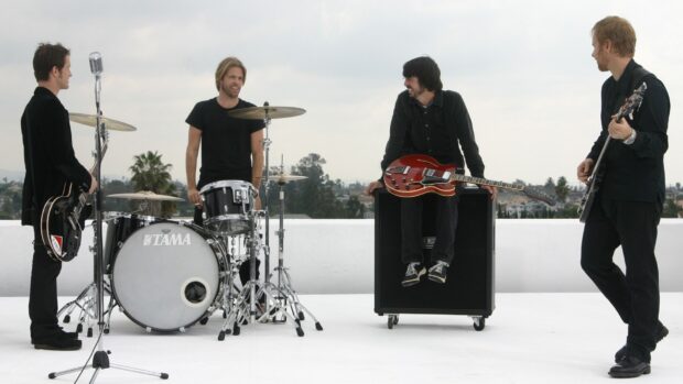 The Foo Fighters band members are gathered with instruments outside during daylight, HD Desktop Wallpaper