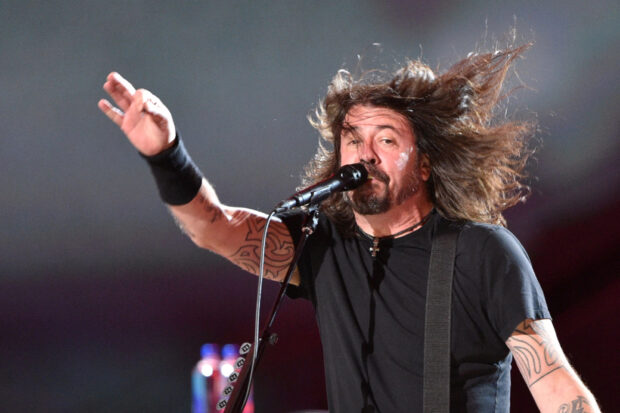The Foo Fighters perform energetically on stage with hair flying, HD Desktop Wallpaper
