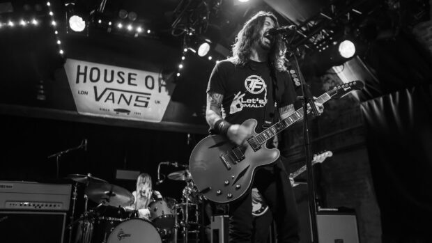 The Foo Fighters performing on stage with guitar and drums, HD Desktop Wallpaper