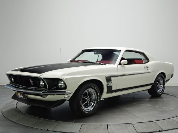 White Ford Mustang Boss 302 parked in studio with black hood and red interior