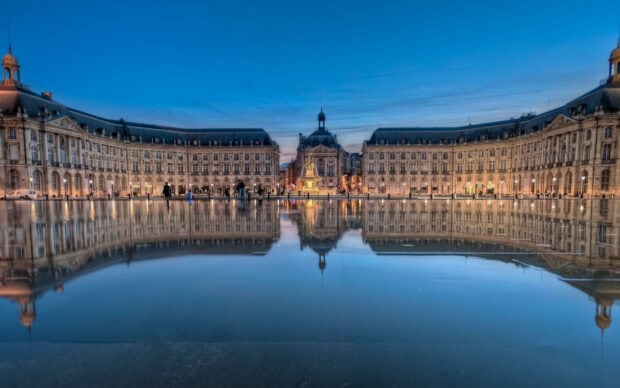The Bordeaux Place de la Bourse reflecting in water during twilight showing France landmark