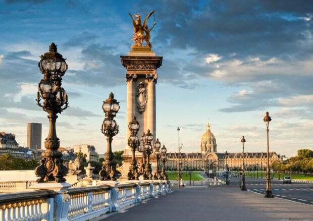 The France historic bridge with golden statues and classical architecture under a blue sky