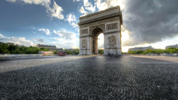 The iconic French monument Arch of Triumph stands tall under a dramatic sky in France