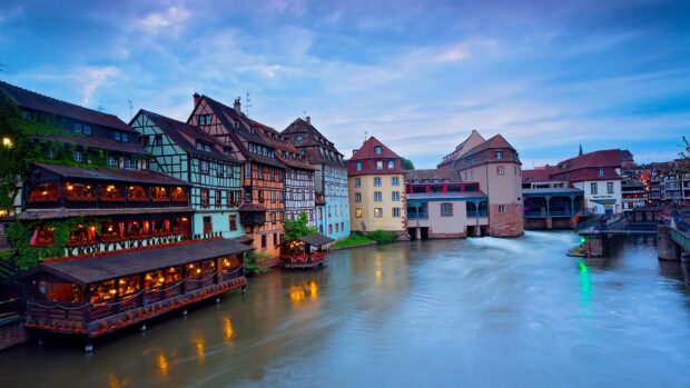 Traditional France architecture with colorful buildings along the river at dusk