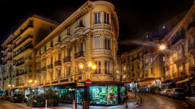 Elegant France architecture with flower shop illuminated at night in city street