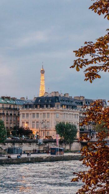 The autumn view of Paris river and buildings with Eiffel Tower in the background