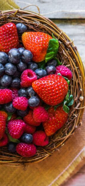A basket filled with fresh strawberries, blueberries, and raspberries captures the essence of berries wallpapers, HD Mobile Wallpaper