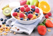 A bowl of cereal topped with fresh raspberries and blueberries, 4K Desktop Wallpaper