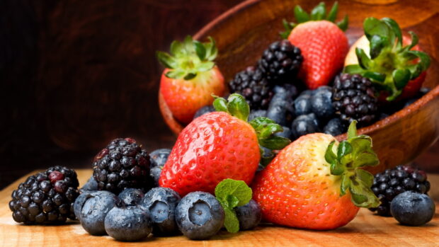 A close up of berries with mint leaves arranged on a wooden board, HD Desktop Wallpaper