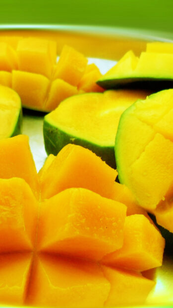 Fresh mango cut into star shapes showing juicy yellow flesh and green skin, HD Mobile Wallpaper