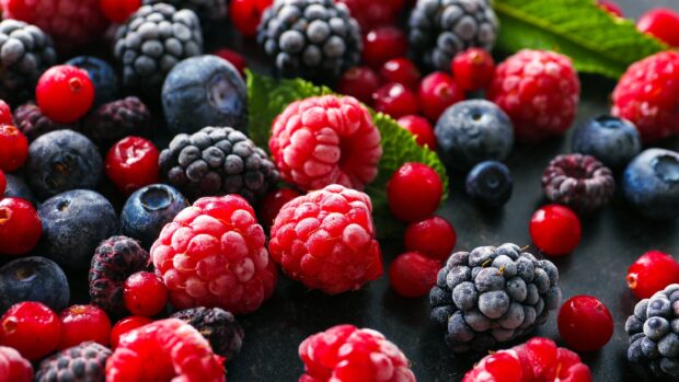 A close up of fresh berries in various shades of red and blue on a dark surface, 2K Desktop Wallpaper