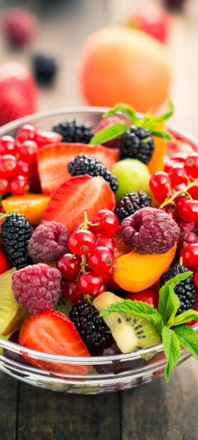 A glass bowl filled with fresh mixed berries and fruit slices shows vibrant colors and textures, HD Mobile Wallpaper