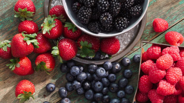A bowl and container with fresh berries and fruits on a rustic wooden surface, HD Desktop Wallpaper