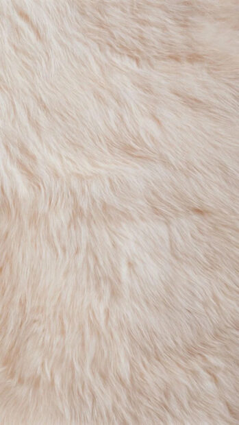 Soft beige fur texture with natural flowing strands on a close up view