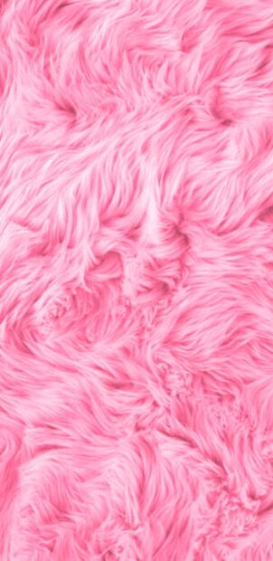 Soft pink fur texture with fluffy strands creating a cozy feeling