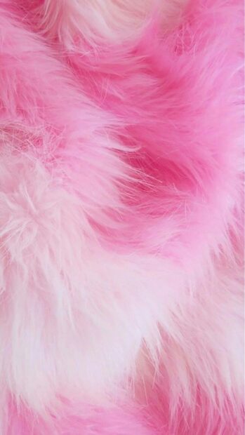 Soft pink fur texture with light and dark pink shades on a fluffy surface