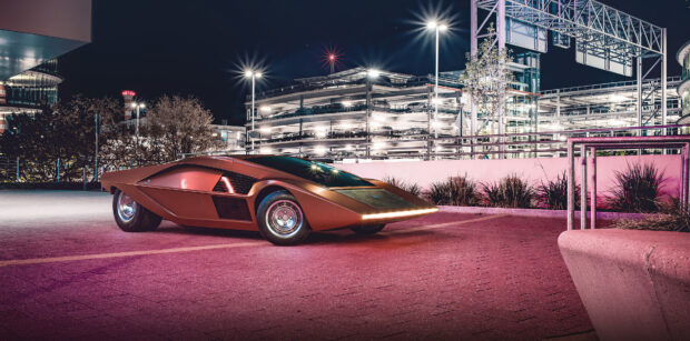 A futuristic Lancia car is parked in an urban setting under bright lights at night, 4K Desktop Wallpaper