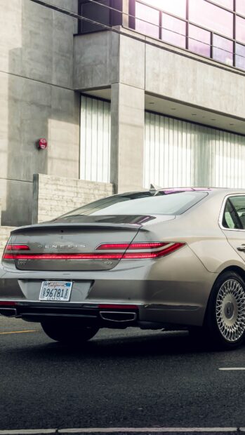 The Genesis Wallpapers car is parked on the street in front of a modern concrete building, 4K Mobile Wallpaper