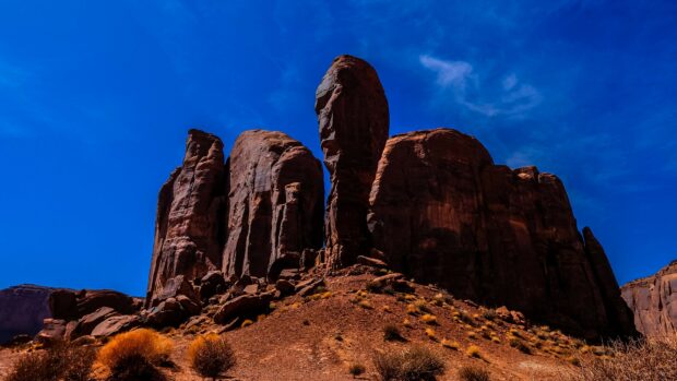 Large rock formations showcasing geology in a desert landscape under a clear blue sky