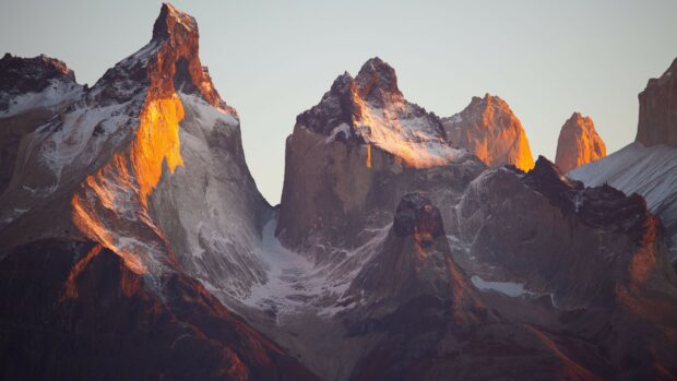 Rocky mountain peaks with geology features glowing in the sunset light