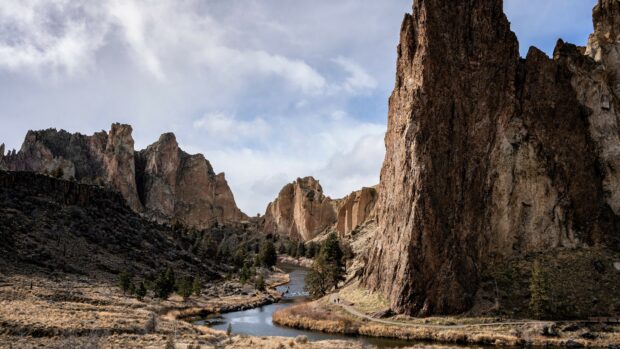 A stunning geology landscape with rocky cliffs and a winding river in a natural canyon setting