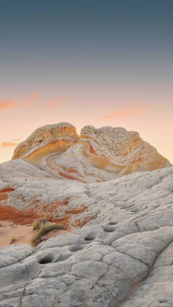 Unique geology formations with layered rock textures at sunset in a desert landscape