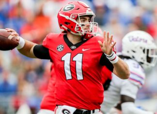 Georgia Bulldogs player wearing red jersey preparing to throw a football during a game