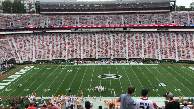 A panoramic view of the Georgia Bulldogs football stadium filled with fans and players on the field