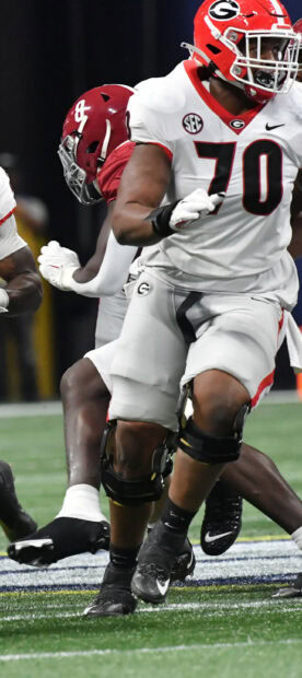 Georgia Bulldogs player running during a football game on the field with defenders nearby