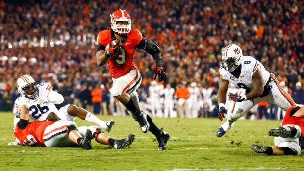 Georgia Bulldogs running with the football during a college game on the field