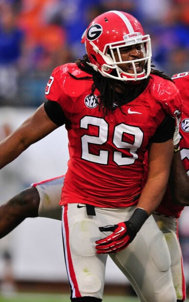 Georgia Bulldogs player in red uniform celebrating on the field during a football game