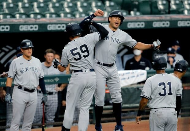 Giancarlo Stanton celebrating with his teammates during a New York Yankees baseball game